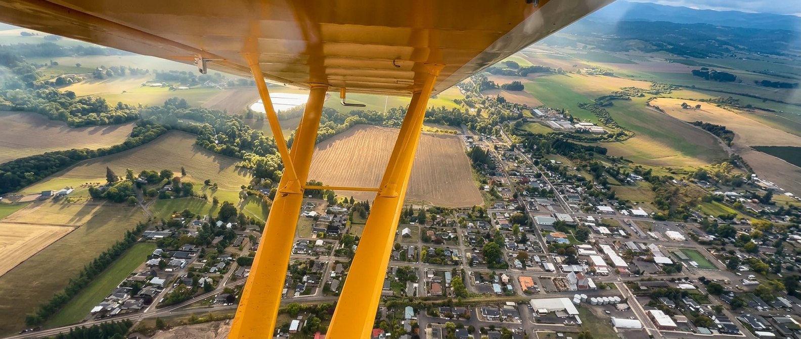Home from another angle — town and countryside beneath the wing.